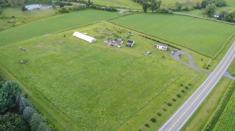 Aerial view of Dropstone Farm showing pasture, the hoop house, buildings, and orchard rows