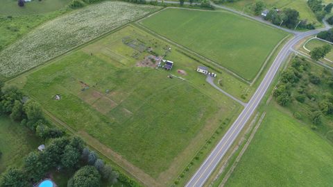 Aerial view of Dropstone Farm showing pasture, the hoop house, buildings, and orchard rows